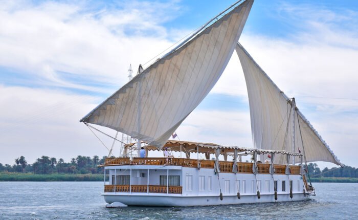 A traditional Dahabiya sailing boat on the Nile during a Dahabiya Nile cruise from Aswan.