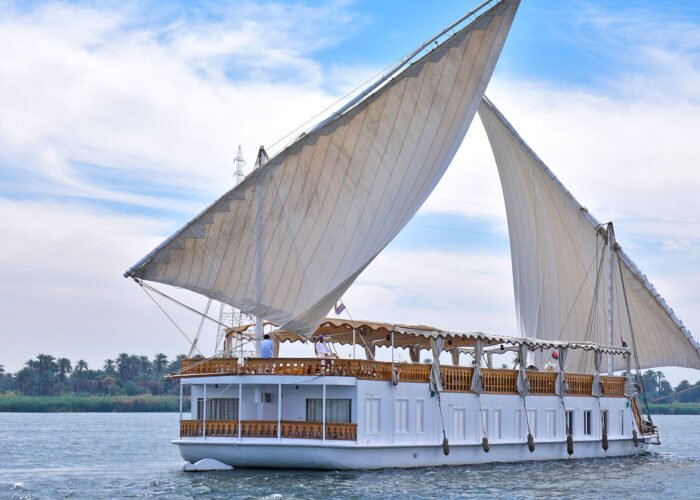 A traditional Dahabiya sailing boat on the Nile during a Dahabiya Nile cruise from Aswan.
