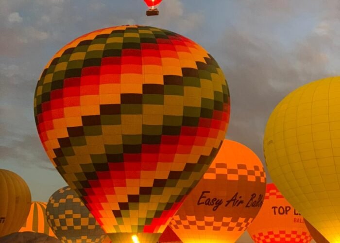 View from a hot air balloon Luxor ride, showing the Valley of the Kings at sunrise.